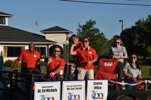 Board of education in float throwing candy